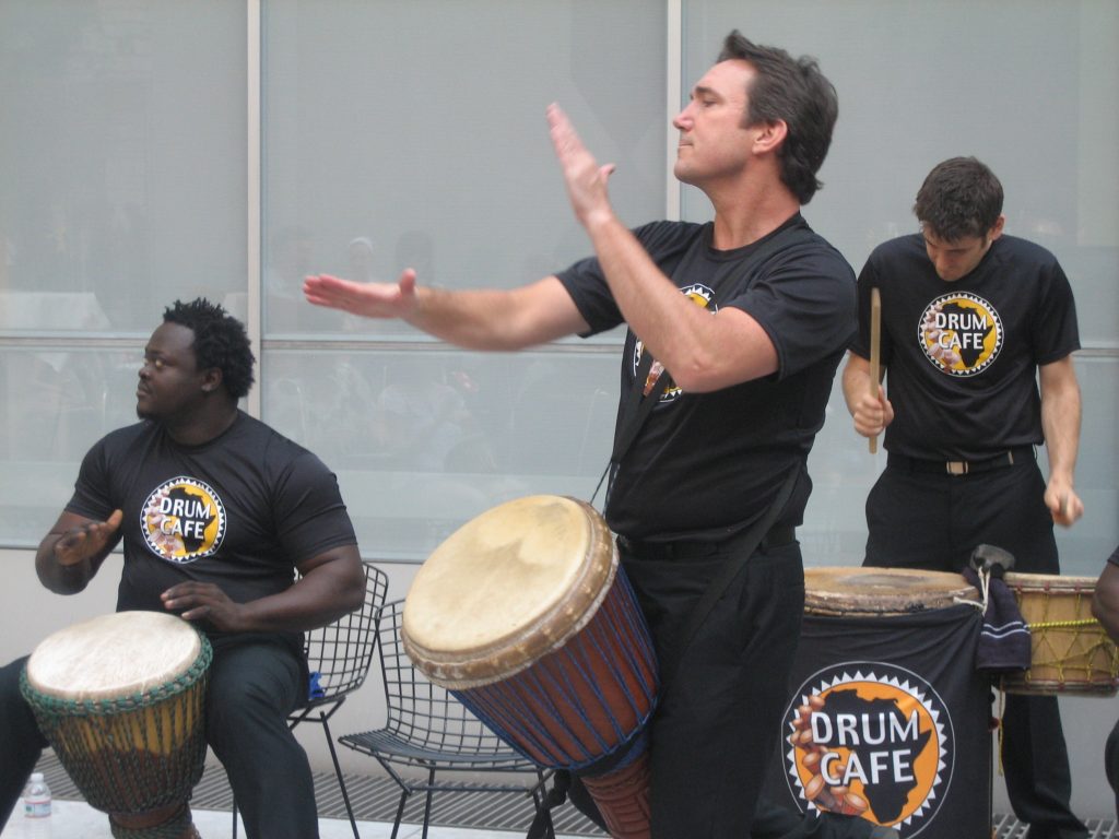 Drum Cafe facilitator leading a corporate drumming event.